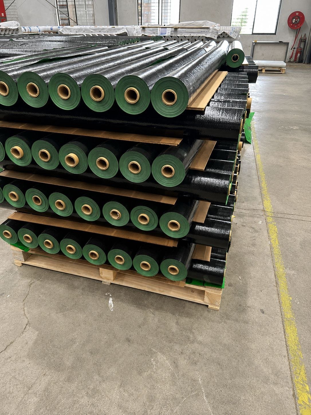 Synthetic Roofing Underlayment — Stacked rolls in production