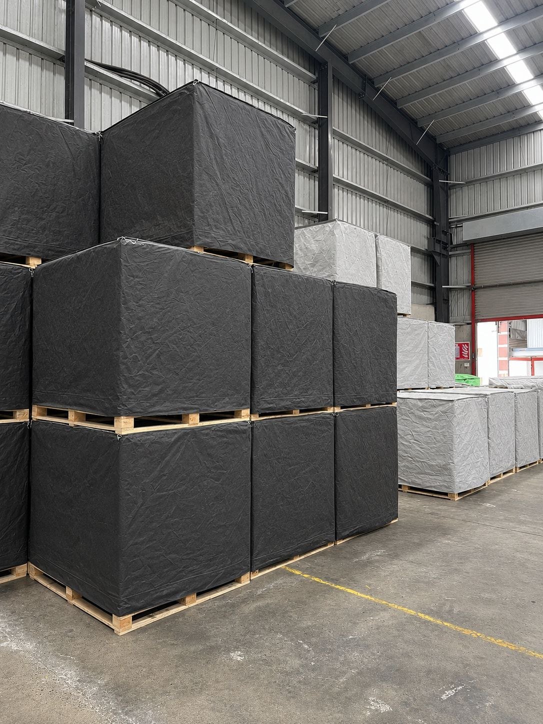 Synthetic Roofing Underlayment — Stacked bundles, warehouse